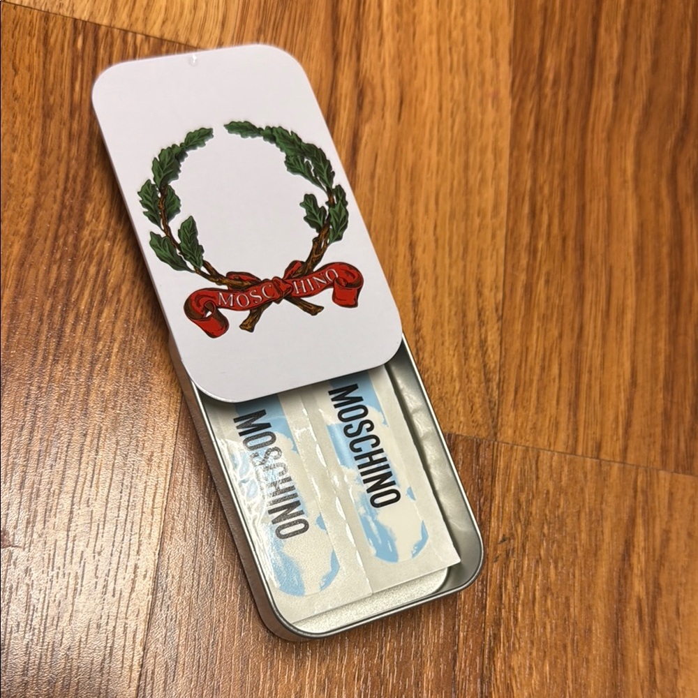 Moschino set of 10 Band-Aids in the metal case.